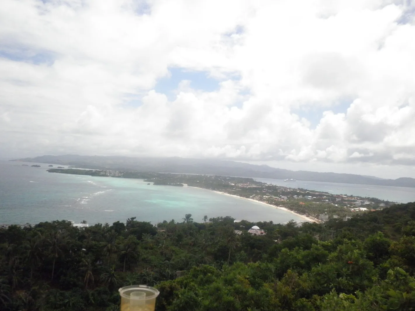 View from Mount Luho summit over Boracay's forested interior toward the coastline