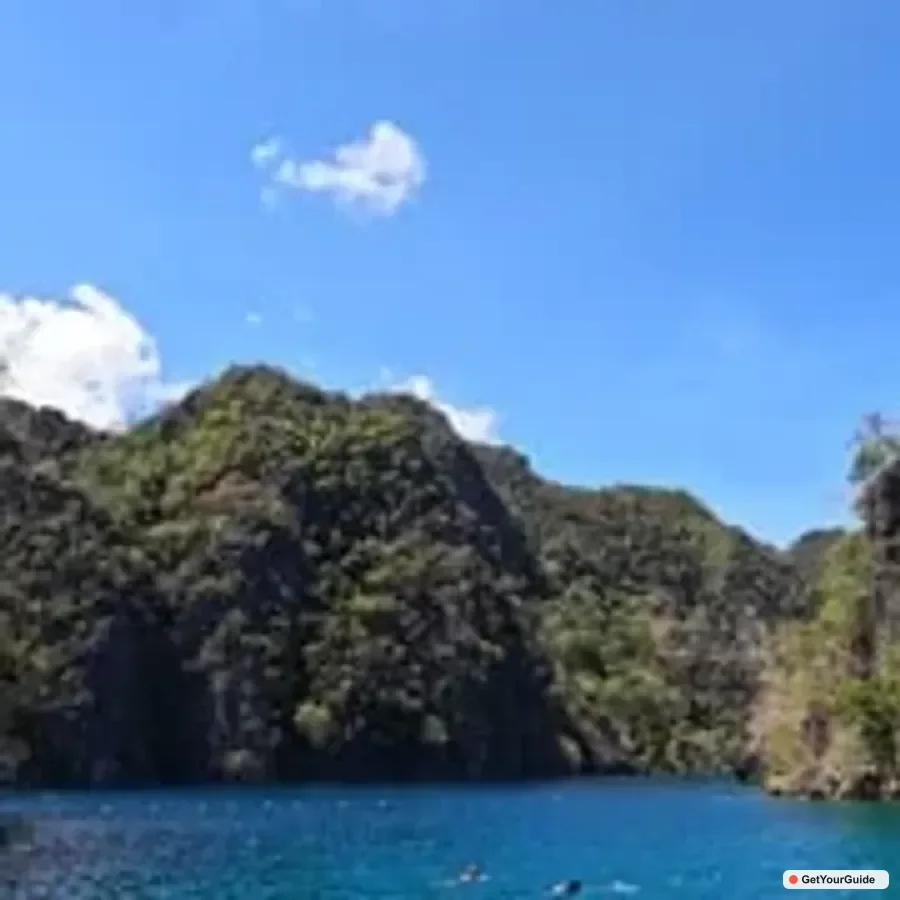 Private boat and moored bangka in a calm Coron cove